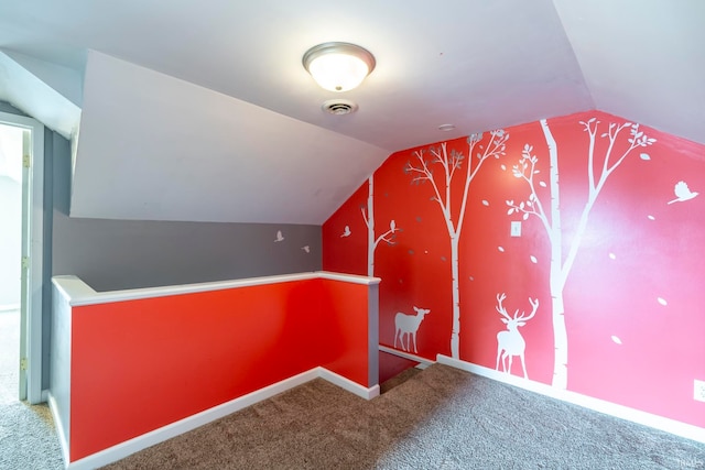 bonus room with lofted ceiling and carpet flooring