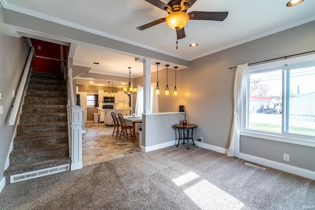 living room with crown molding, carpet, and ceiling fan with notable chandelier