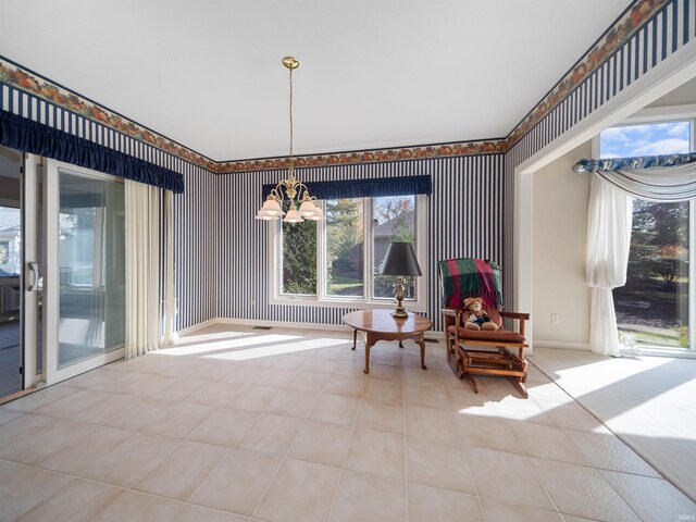 sitting room featuring a notable chandelier and light tile patterned flooring