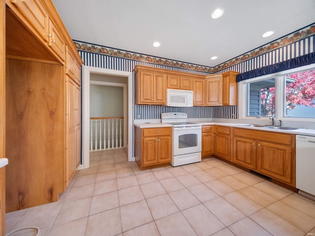 kitchen with sink, light tile patterned floors, backsplash, and white appliances