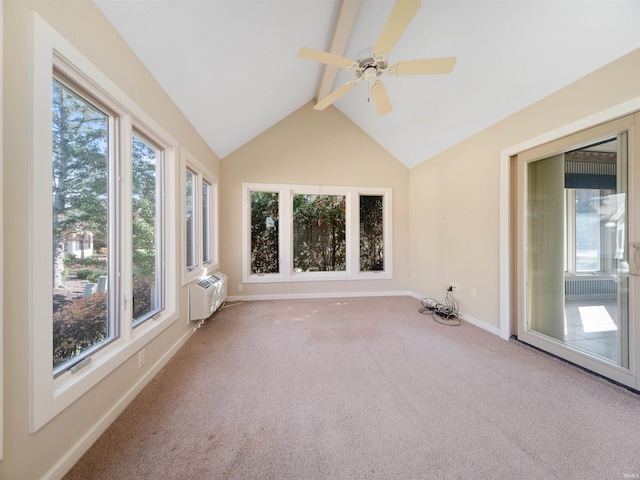 unfurnished sunroom featuring a wealth of natural light, vaulted ceiling with beams, a wall mounted air conditioner, and ceiling fan