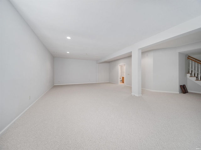 basement featuring light carpet