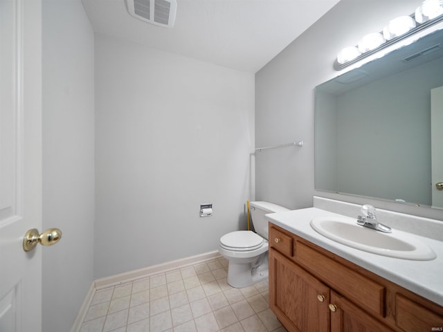 bathroom with vanity, toilet, and tile patterned floors