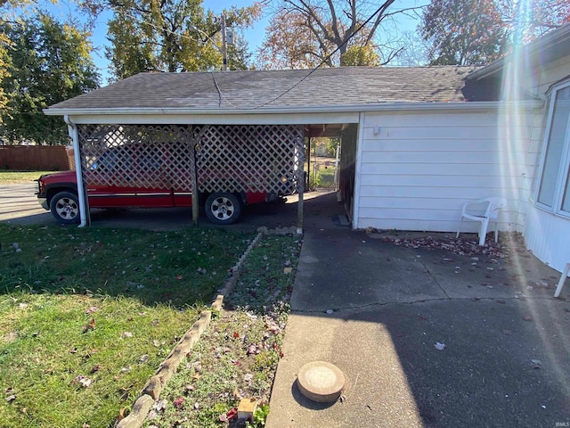 view of home's exterior featuring a lawn, a carport, and roof with shingles