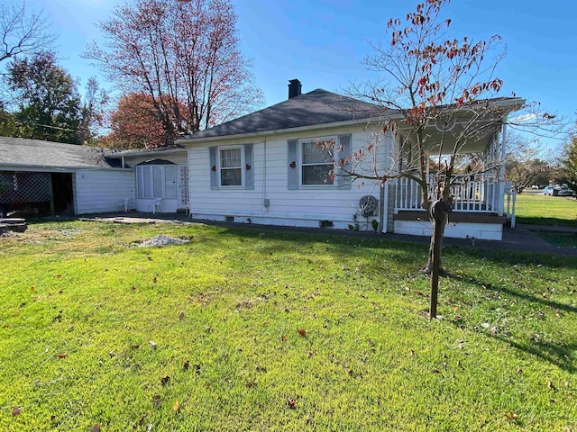 ranch-style home with a front yard, crawl space, and a chimney