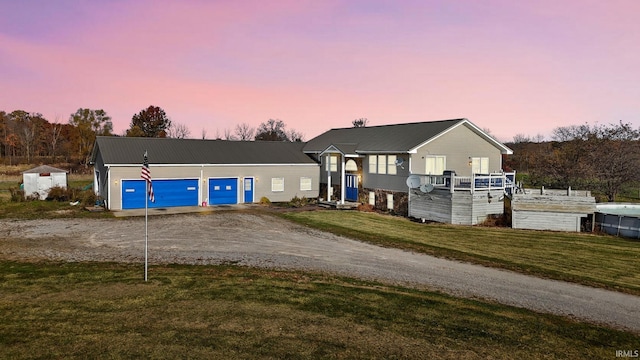 view of front of house featuring a garage and a lawn