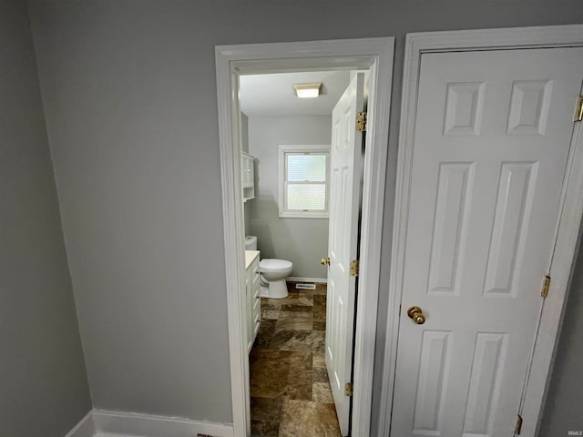 bathroom featuring vanity and toilet