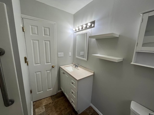 bathroom with vanity and toilet