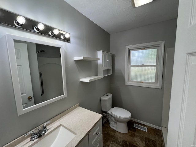 bathroom with toilet, a textured ceiling, and vanity