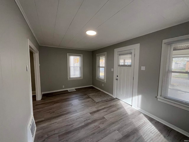 entryway featuring crown molding and hardwood / wood-style flooring