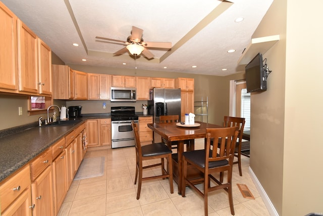 kitchen with sink, appliances with stainless steel finishes, a textured ceiling, and ceiling fan