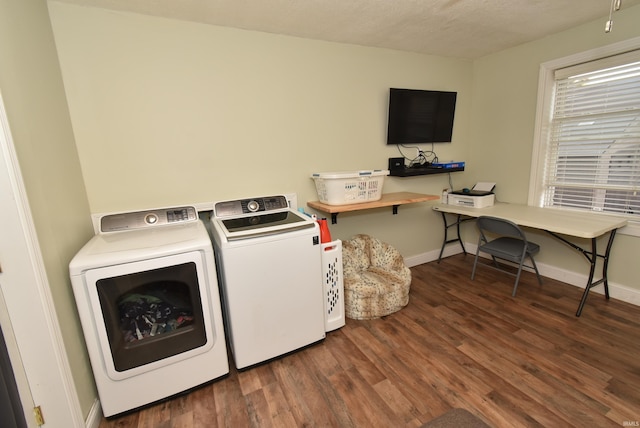 laundry room featuring washer and dryer, a textured ceiling, and dark hardwood / wood-style floors