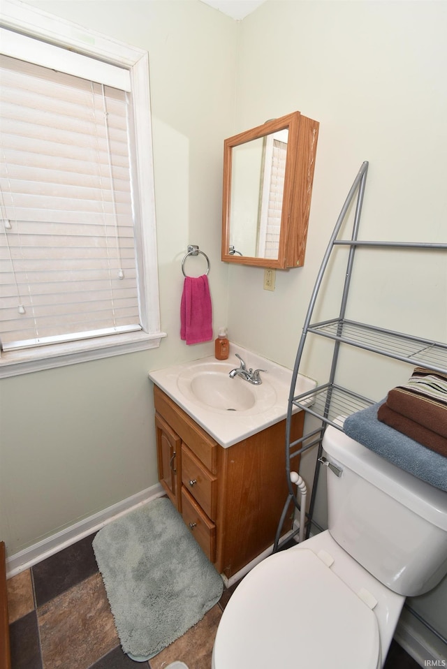 bathroom featuring toilet and vanity