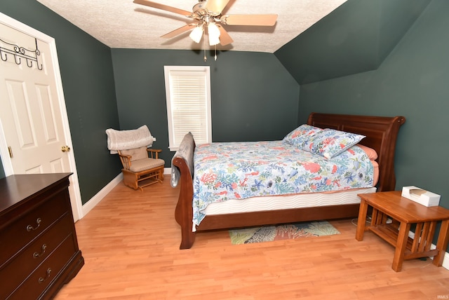 bedroom featuring ceiling fan, a textured ceiling, and light wood-type flooring