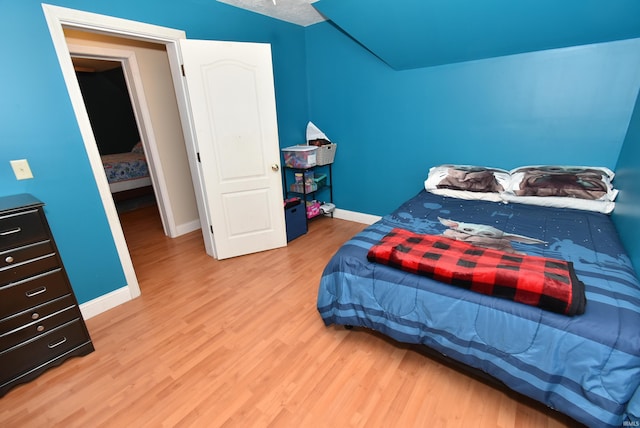 bedroom with hardwood / wood-style flooring