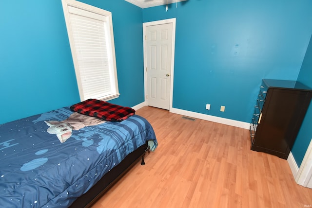 bedroom with light hardwood / wood-style floors