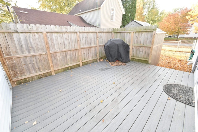 wooden deck with a grill