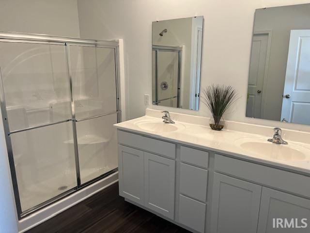 bathroom featuring vanity, walk in shower, and hardwood / wood-style flooring