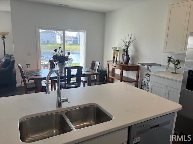 kitchen with appliances with stainless steel finishes, white cabinets, and sink