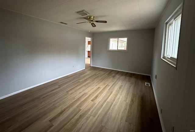 spare room featuring light hardwood / wood-style floors and ceiling fan