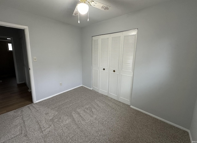 unfurnished bedroom with a closet, carpet, and ceiling fan