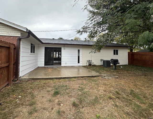 back of house with a yard, a patio area, and cooling unit