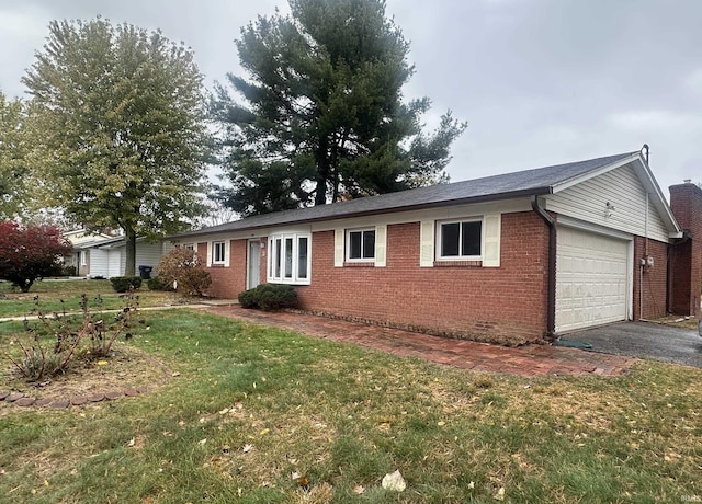 view of side of property featuring a yard and a garage