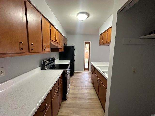 kitchen with light hardwood / wood-style floors, black appliances, and sink