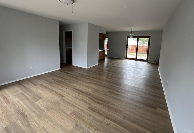 interior space featuring a notable chandelier and hardwood / wood-style flooring