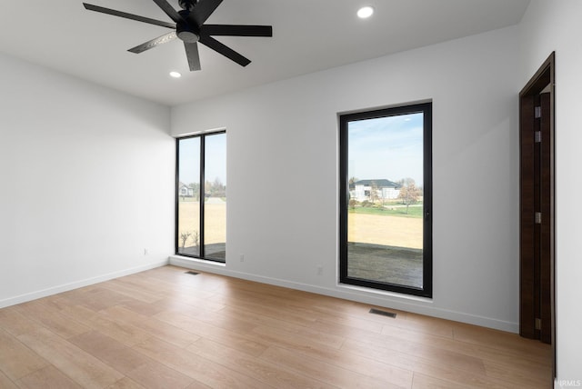 empty room with light hardwood / wood-style floors and ceiling fan