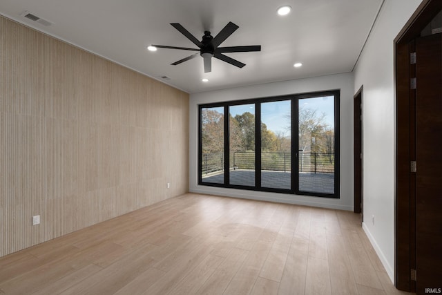 empty room featuring light wood-type flooring and ceiling fan