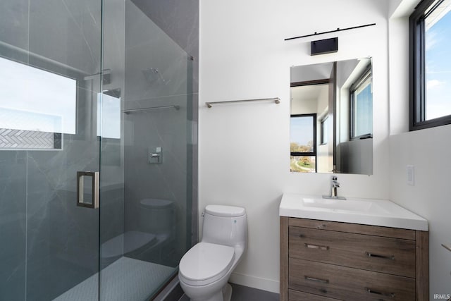 bathroom with vanity, toilet, and a shower with door