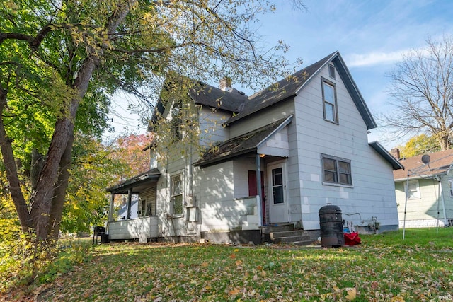 back of property featuring a yard