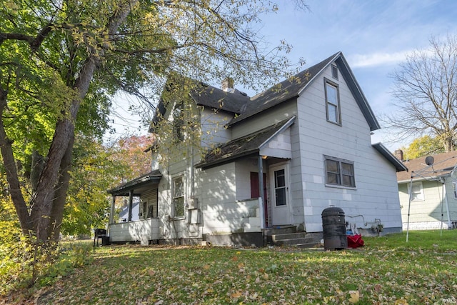 1815 Elwood Ave, South Bend, IN 46628 - back of property featuring a lawn and a chimney