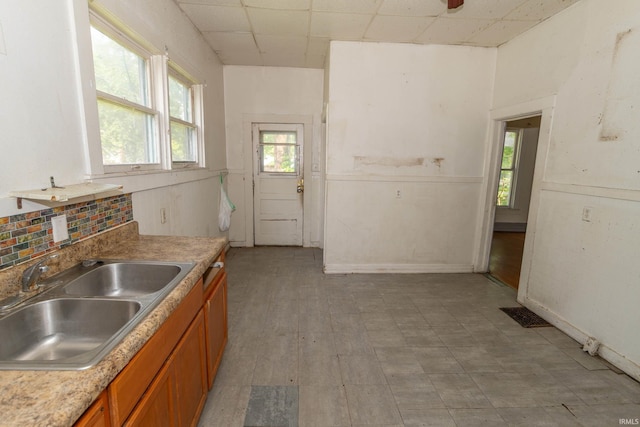 1815 Elwood Ave, South Bend, IN 46628 - kitchen with a sink, brown cabinets, a drop ceiling, light floors, and light countertops