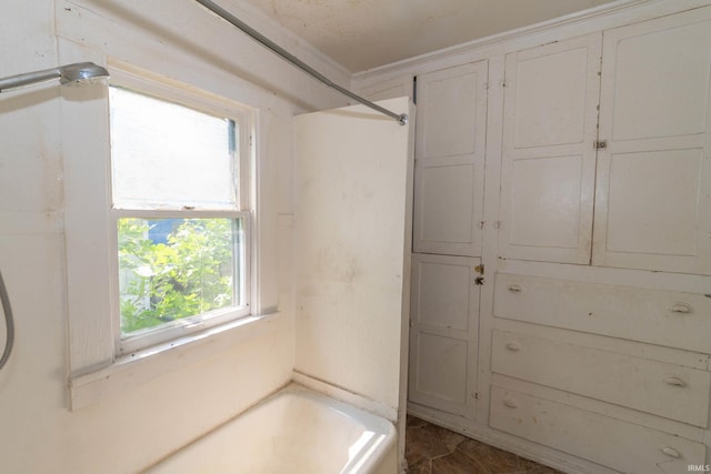 1815 Elwood Ave, South Bend, IN 46628 - bathroom featuring a tub, ornamental molding, and marble finish floors