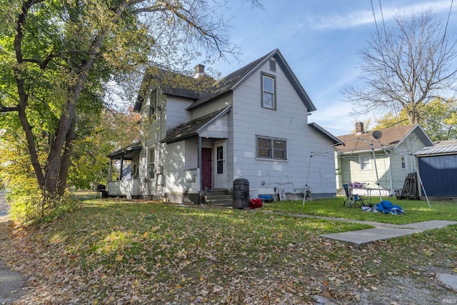 1815 Elwood Ave, South Bend, IN 46628 - view of front of property featuring a front lawn and a chimney