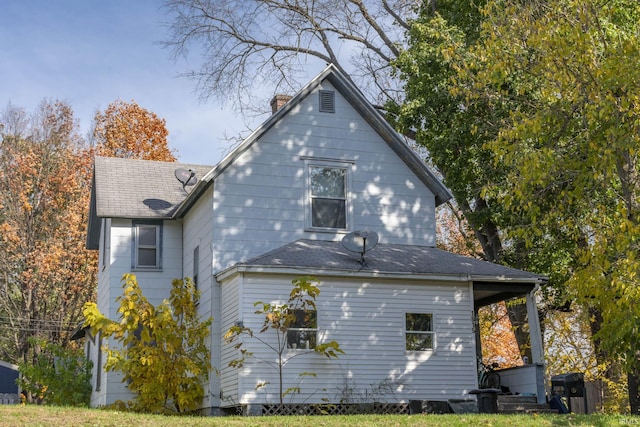 1815 Elwood Ave, South Bend, IN 46628 - rear view of house with a shingled roof and a chimney