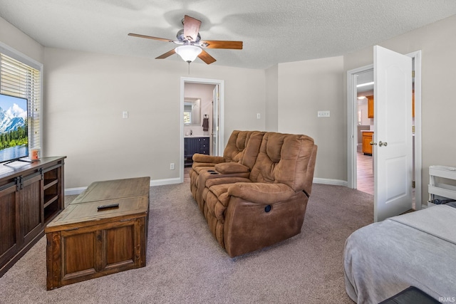 living room featuring light carpet, a textured ceiling, and ceiling fan