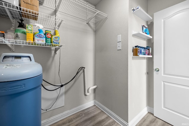 clothes washing area featuring hardwood / wood-style flooring