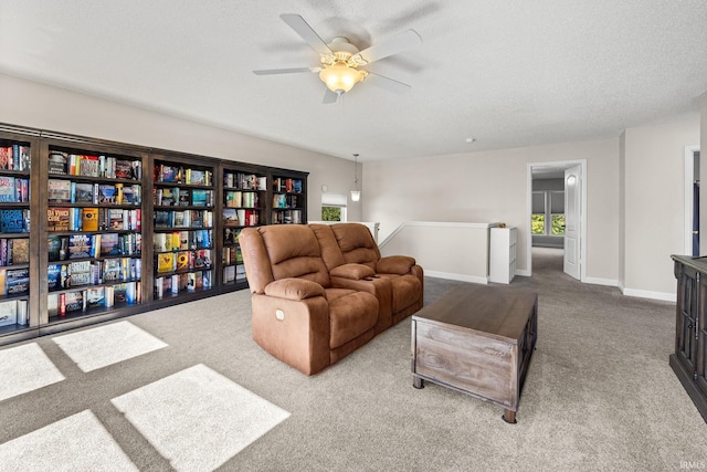 living room with light carpet, a textured ceiling, and ceiling fan