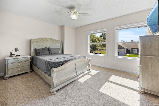 carpeted bedroom featuring a textured ceiling and ceiling fan