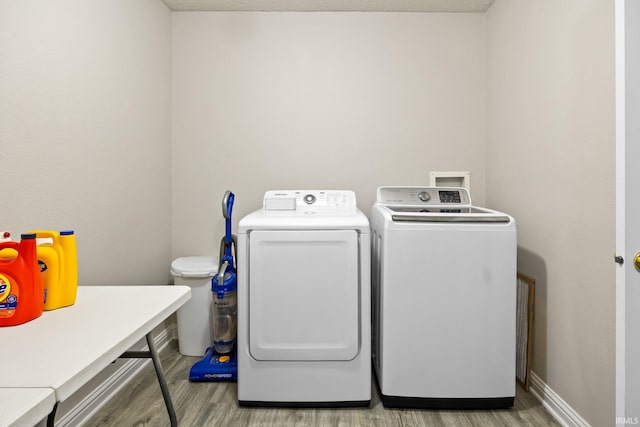 laundry room with hardwood / wood-style floors, a textured ceiling, and washer and clothes dryer