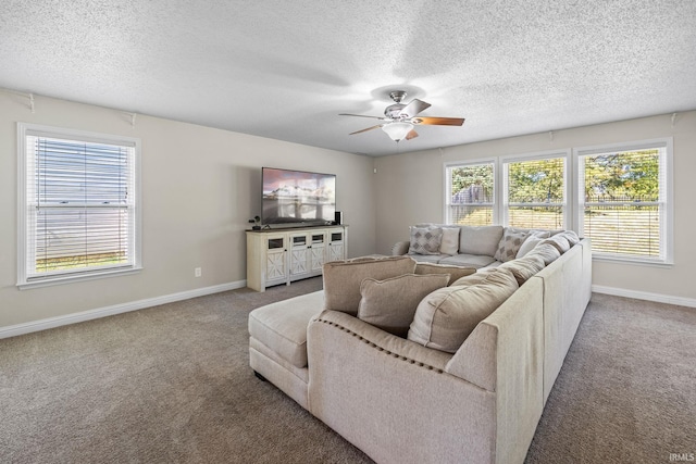 carpeted living room featuring ceiling fan, a healthy amount of sunlight, and a textured ceiling