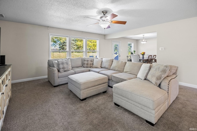 living room with a textured ceiling, carpet, and ceiling fan