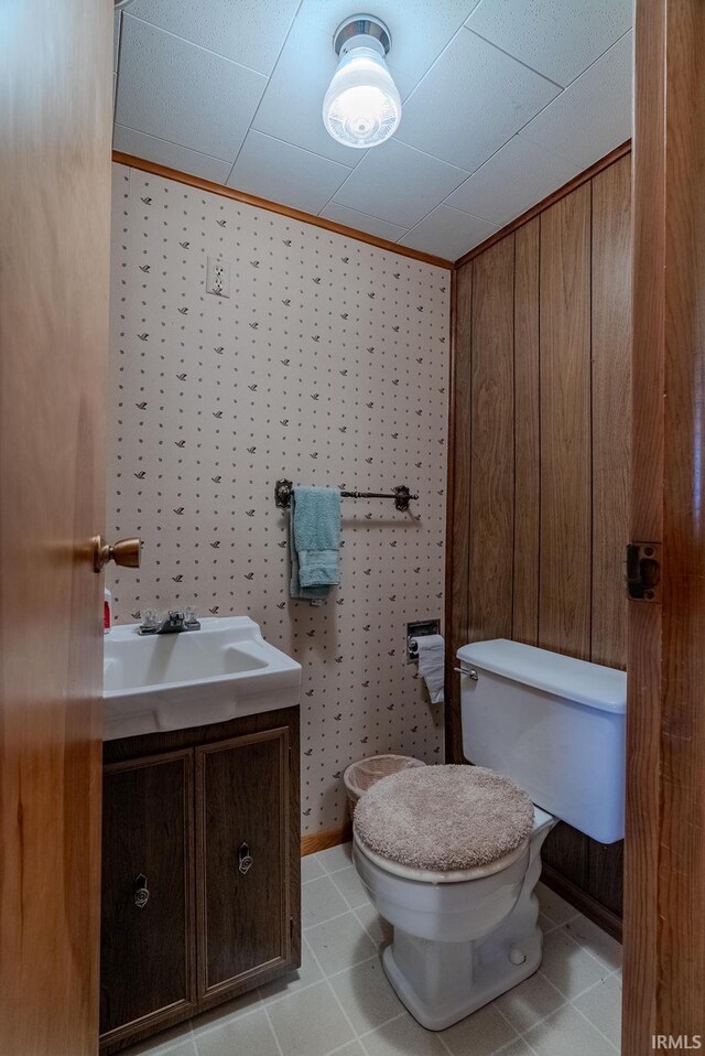 bathroom with vanity, ornamental molding, toilet, and tile patterned floors