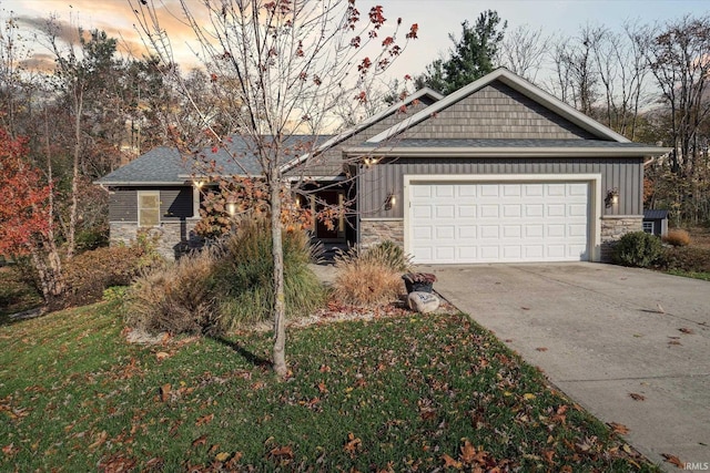 view of front of property featuring a garage and a lawn