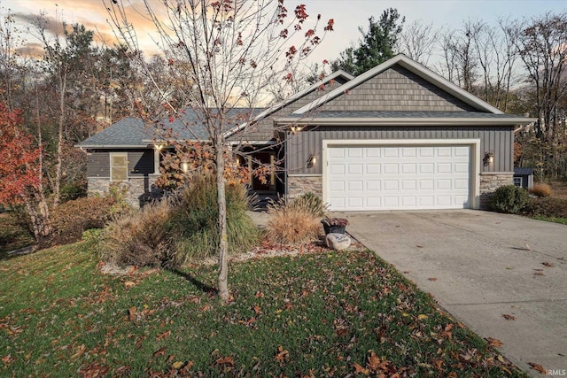 313 Tiger Ct, New Carlisle, IN 46552 - view of front of home with stone siding, board and batten siding, driveway, an attached garage, and a front yard