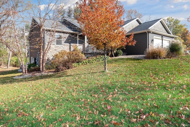 313 Tiger Ct, New Carlisle, IN 46552 - view of front of home featuring a front yard, an attached garage, stone siding, and a shingled roof