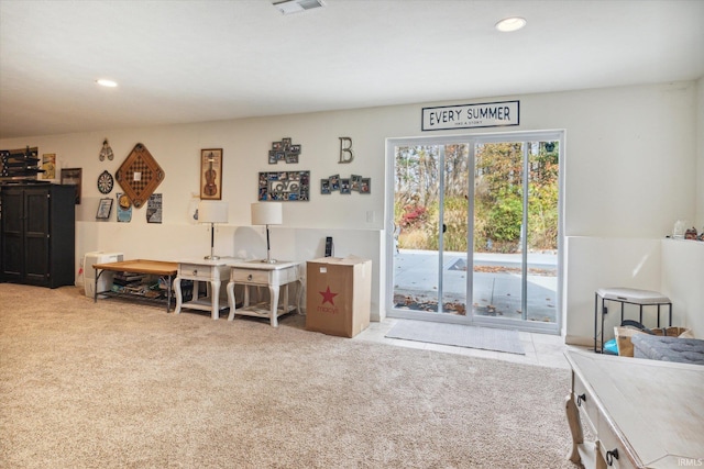 miscellaneous room featuring light carpet